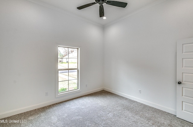 carpeted empty room with ceiling fan and crown molding