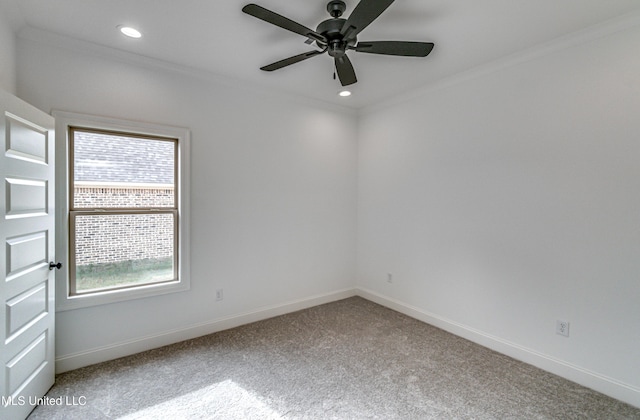 carpeted empty room featuring ceiling fan and crown molding