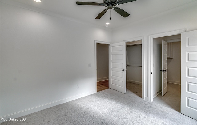 unfurnished bedroom featuring light colored carpet, ceiling fan, and ornamental molding