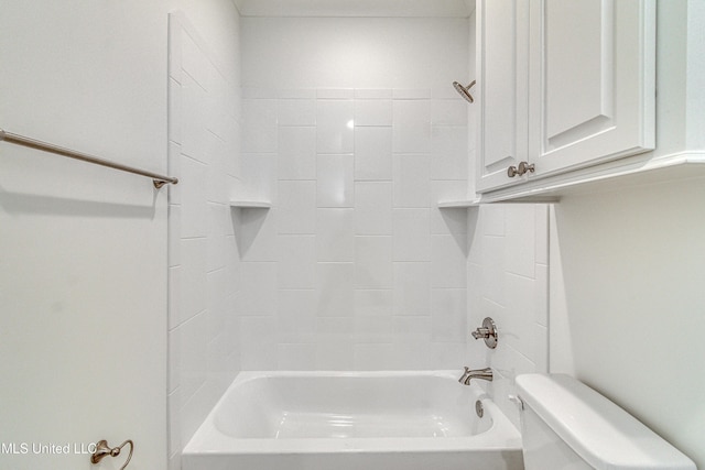 bathroom featuring tiled shower / bath combo and toilet