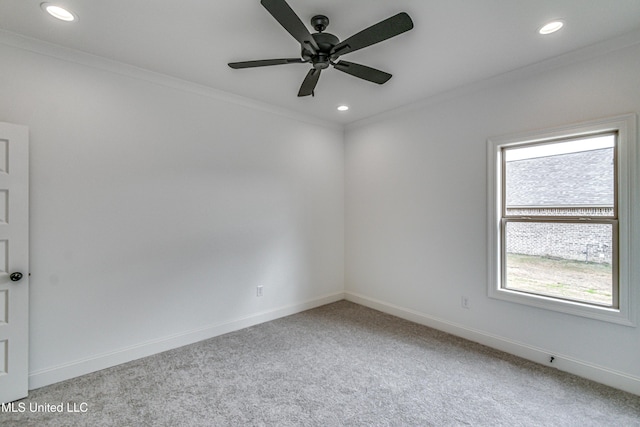 empty room featuring ceiling fan, carpet floors, and ornamental molding