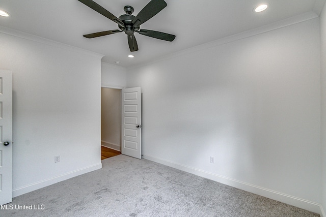 spare room featuring carpet flooring, ceiling fan, and crown molding