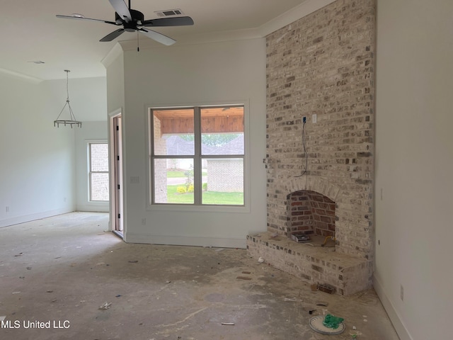 unfurnished living room featuring ceiling fan and ornamental molding