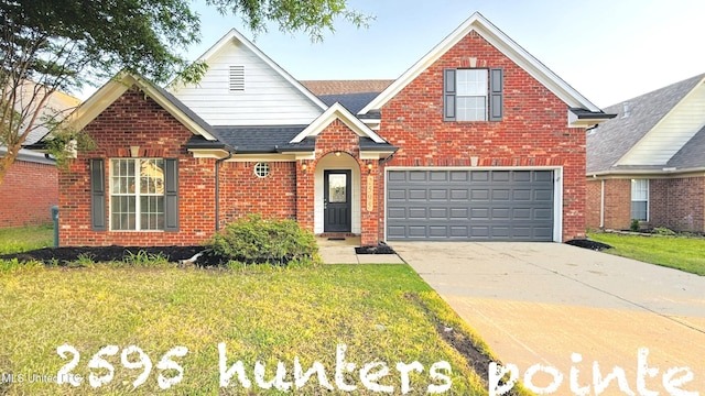 2595 Hunters Pointe Dr, Southaven, MS 38672 - traditional-style house featuring brick siding, a garage, a front lawn, roof with shingles, and concrete driveway