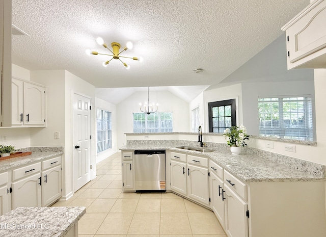 2595 Hunters Pointe Dr, Southaven, MS 38672 - kitchen featuring stainless steel dishwasher, a chandelier, lofted ceiling, light tile patterned floors, and white cabinets