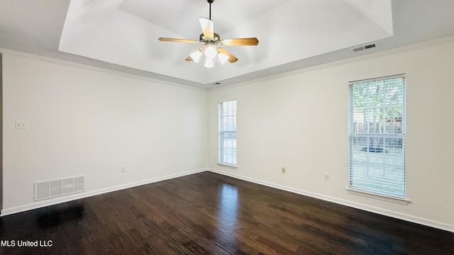 2595 Hunters Pointe Dr, Southaven, MS 38672 - spare room with dark wood-style flooring, a tray ceiling, healthy amount of natural light, a ceiling fan, and crown molding