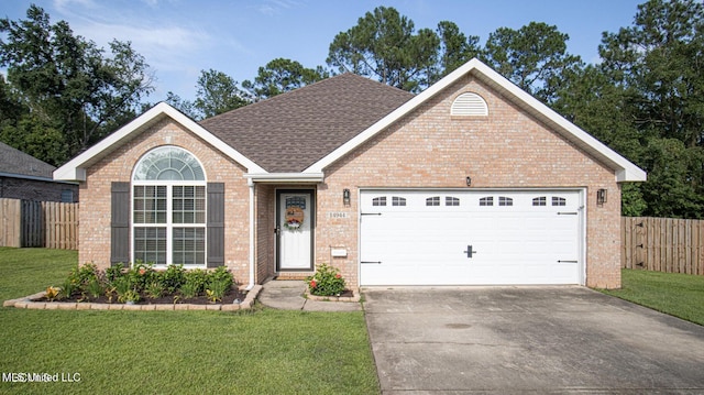 ranch-style home with a front lawn, fence, concrete driveway, a garage, and brick siding