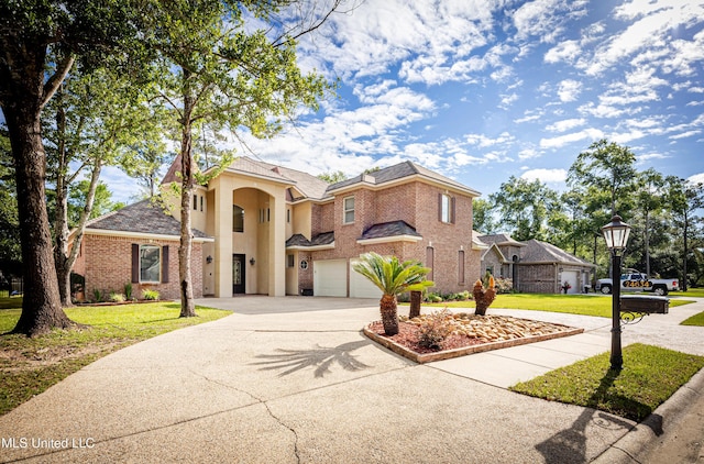 view of front of house featuring driveway, an attached garage, a front lawn, and brick siding