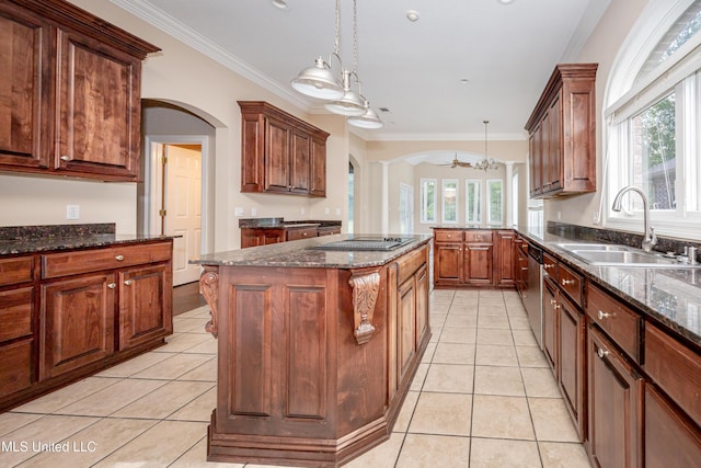 kitchen featuring a sink, arched walkways, ceiling fan, stovetop with downdraft, and crown molding