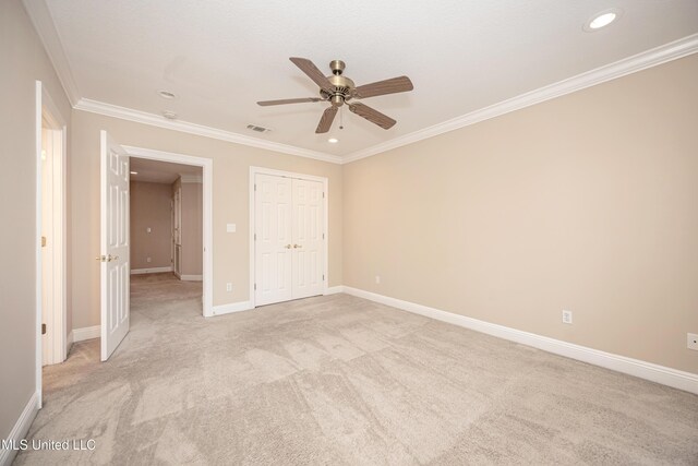 unfurnished bedroom with recessed lighting, crown molding, light carpet, baseboards, and a closet