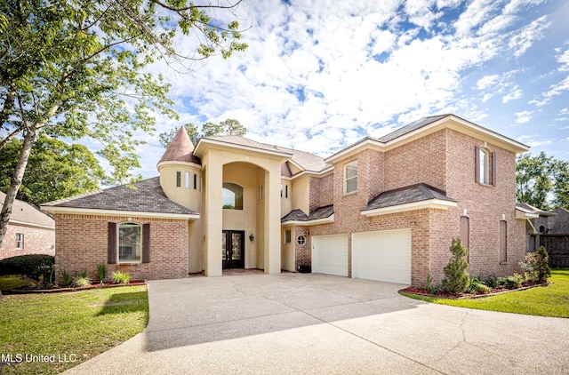 view of front of house with driveway, brick siding, an attached garage, a front lawn, and a shingled roof