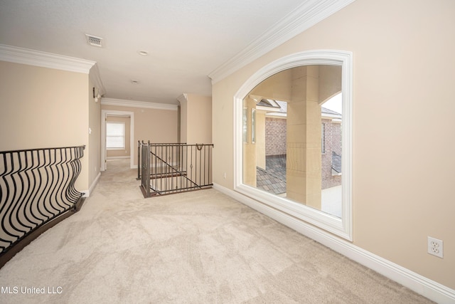 corridor featuring an upstairs landing, ornamental molding, carpet floors, baseboards, and arched walkways