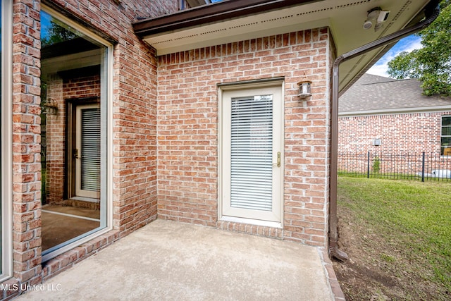 entrance to property featuring brick siding