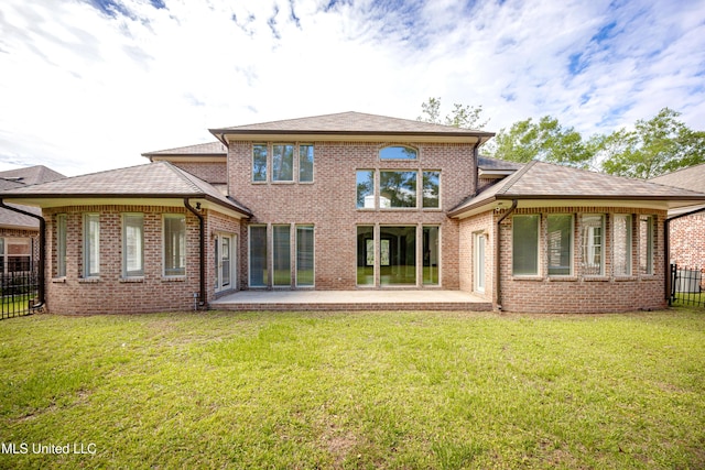 back of house with a patio and brick siding