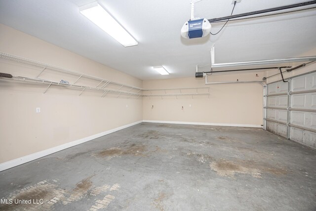 garage with a garage door opener and baseboards