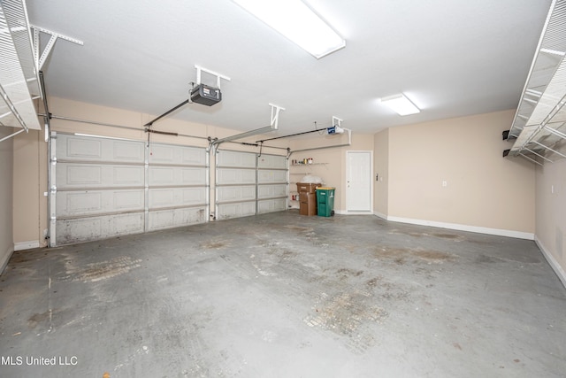 garage featuring a garage door opener and baseboards