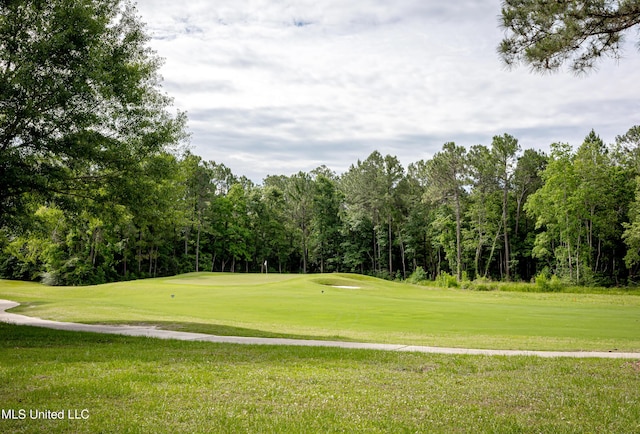 view of community featuring a yard and golf course view