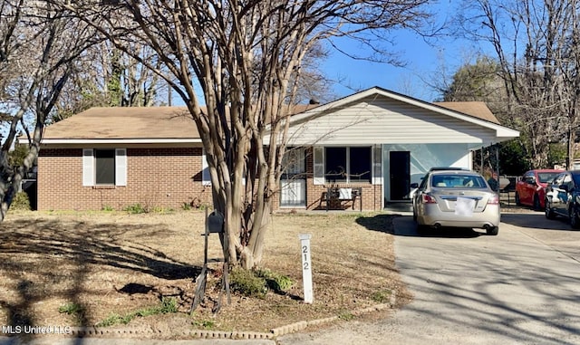 ranch-style home featuring a carport