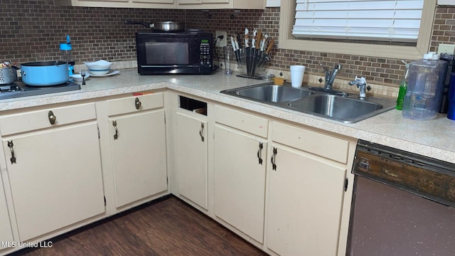 kitchen featuring white cabinetry, dishwasher, and sink