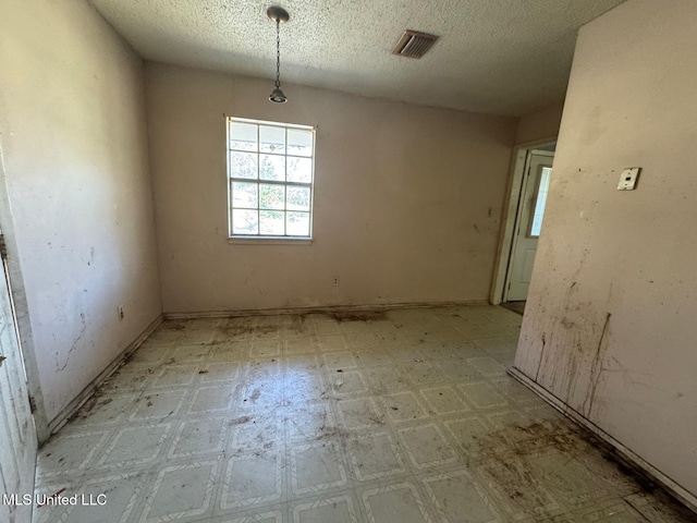 908 Wabash Ave, Vicksburg, MS 39183 - unfurnished dining area featuring visible vents, light floors, and a textured ceiling