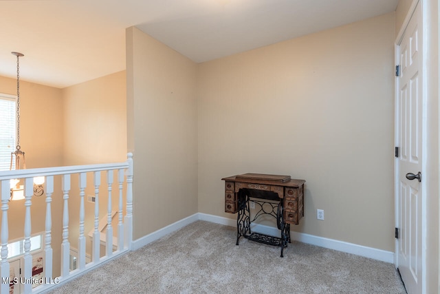 hallway featuring light colored carpet