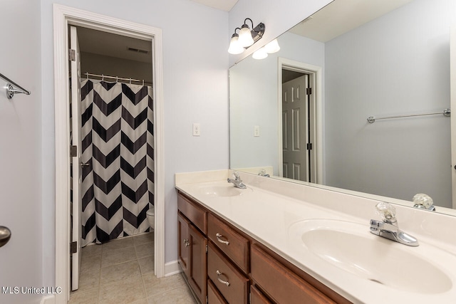 bathroom featuring vanity, walk in shower, toilet, and tile patterned floors