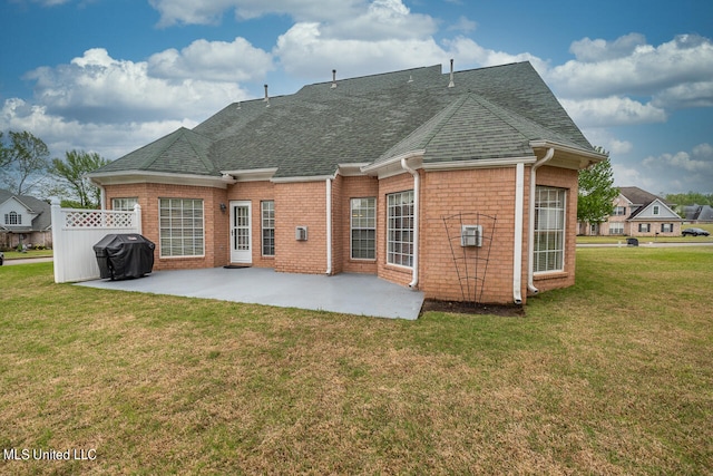 rear view of property with a patio area and a lawn