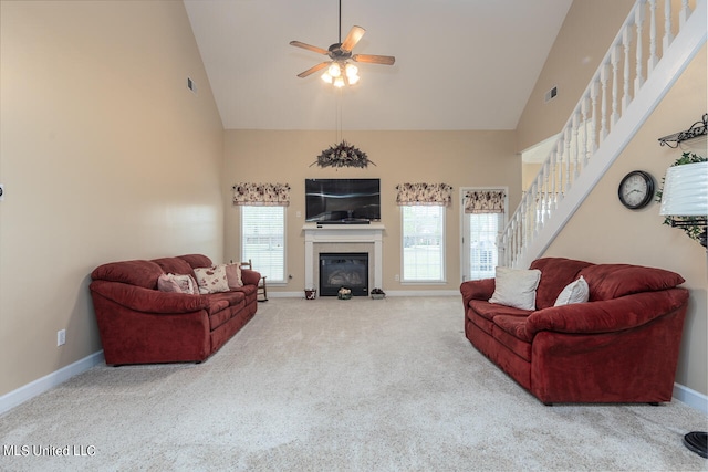 carpeted living room featuring high vaulted ceiling and ceiling fan