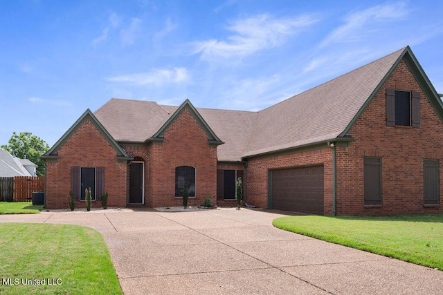 8992 Gavin Dr, Olive Branch, MS 38654 - view of front facade featuring concrete driveway, brick siding, cooling unit, roof with shingles, and an attached garage