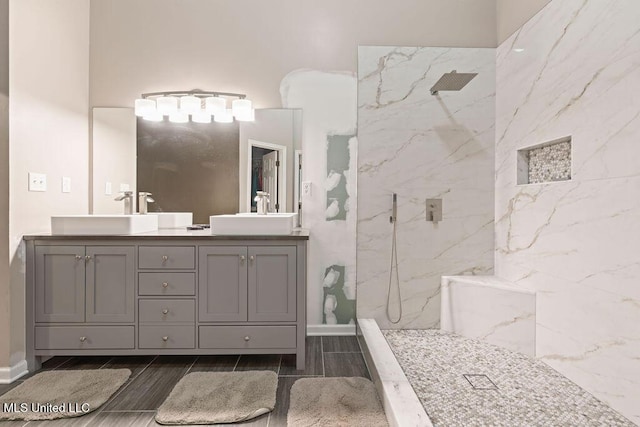 8992 Gavin Dr, Olive Branch, MS 38654 - full bathroom featuring a marble finish shower, double vanity, and wood finish floors