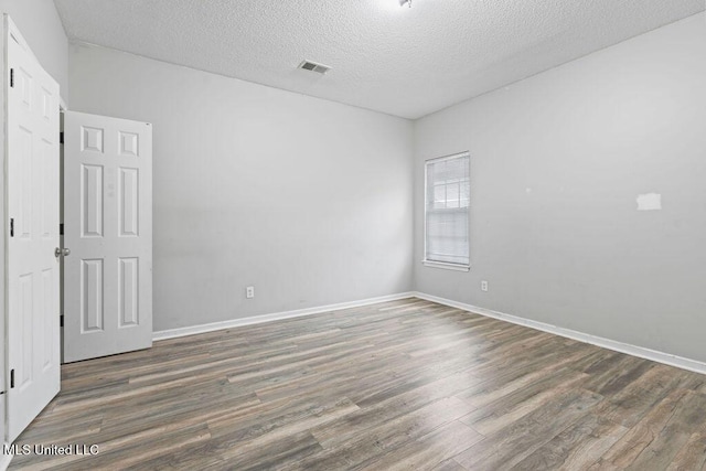 8992 Gavin Dr, Olive Branch, MS 38654 - spare room with wood finished floors, a textured ceiling, and baseboards