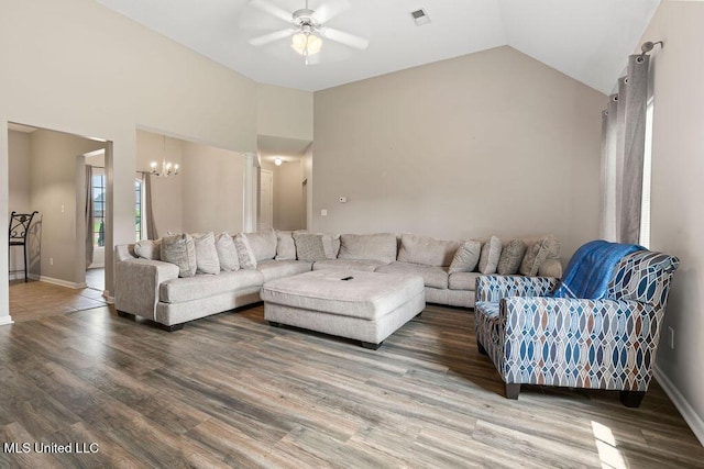 8992 Gavin Dr, Olive Branch, MS 38654 - living area featuring a ceiling fan, a chandelier, wood finished floors, baseboards, and high vaulted ceiling