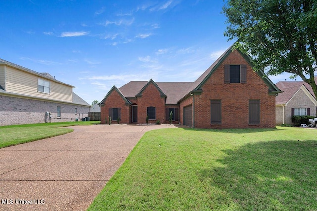 8992 Gavin Dr, Olive Branch, MS 38654 - view of front facade with brick siding, driveway, a front yard, and an attached garage