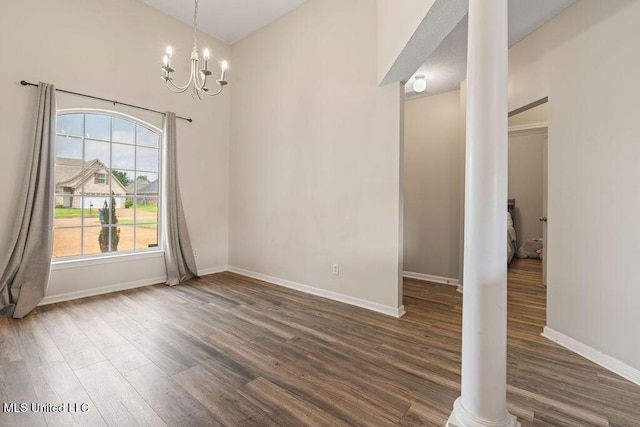 8992 Gavin Dr, Olive Branch, MS 38654 - unfurnished dining area with wood finished floors, a chandelier, and baseboards