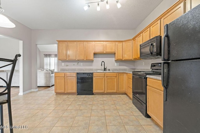 8992 Gavin Dr, Olive Branch, MS 38654 - kitchen featuring black appliances, a sink, light countertops, light tile patterned floors, and light brown cabinets