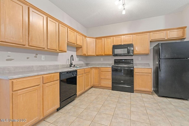 8992 Gavin Dr, Olive Branch, MS 38654 - kitchen with black appliances, a sink, light brown cabinets, light tile patterned floors, and light countertops