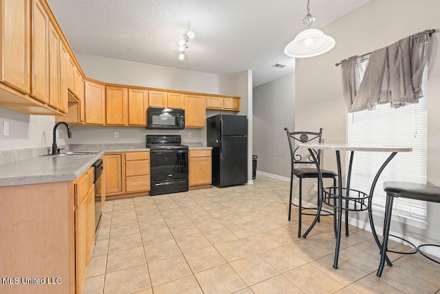 8992 Gavin Dr, Olive Branch, MS 38654 - kitchen featuring black appliances, light countertops, a sink, light tile patterned floors, and pendant lighting
