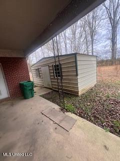 5685 Carrollton Rd, Grenada, MS 38901 - view of patio with an outbuilding