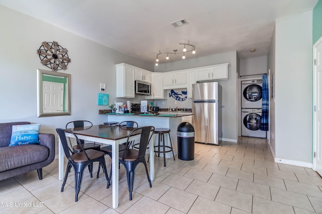 dining space with stacked washer / dryer