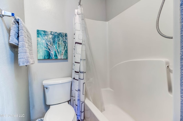 bathroom with shower / bath combo and toilet