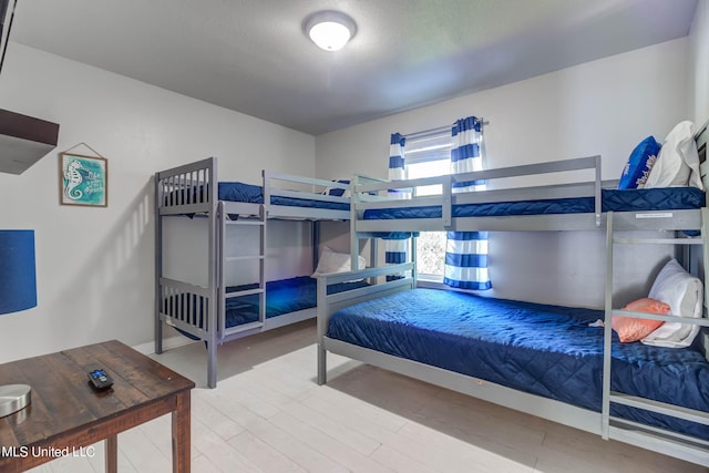 bedroom with hardwood / wood-style floors