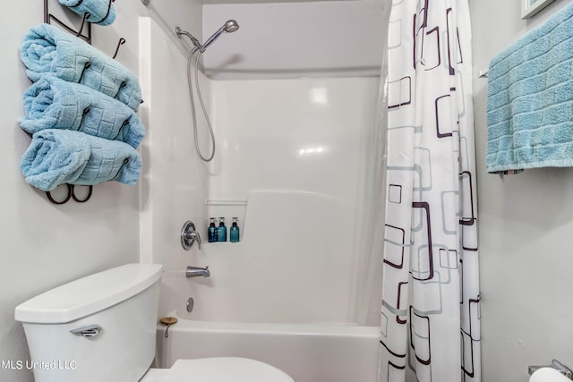 bathroom with toilet and shower / bath combo with shower curtain