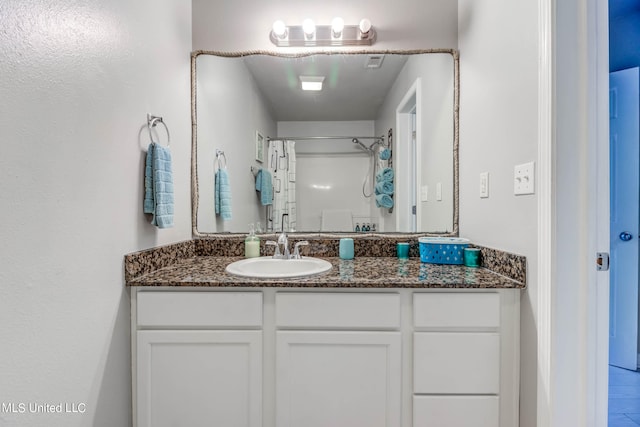 bathroom featuring vanity, hardwood / wood-style flooring, and walk in shower