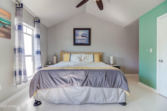 bedroom with lofted ceiling, hardwood / wood-style floors, and ceiling fan