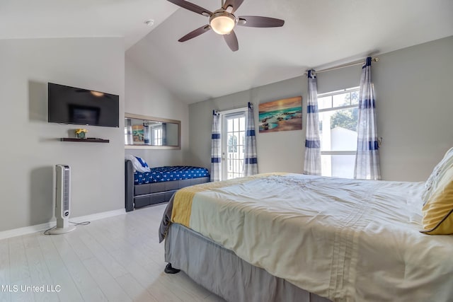 bedroom featuring light hardwood / wood-style floors, vaulted ceiling, and ceiling fan