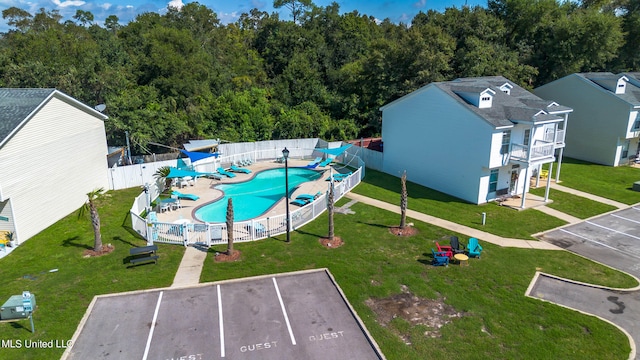 view of swimming pool featuring a yard and a patio