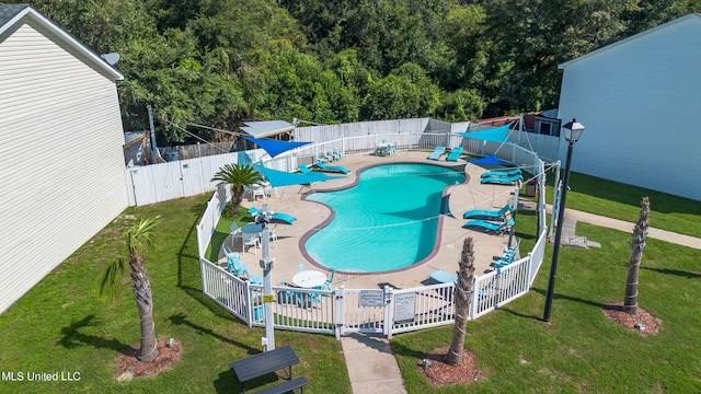 view of pool with a yard and a patio area