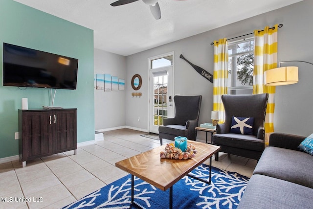 tiled living room featuring ceiling fan, a healthy amount of sunlight, and a textured ceiling