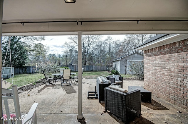 view of patio with outdoor lounge area and an outbuilding