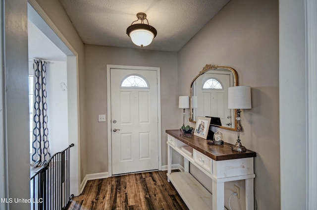 foyer entrance featuring dark hardwood / wood-style floors and a textured ceiling